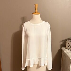 Long sleeve top with flowing ruffles at bottom. Keyhole opening in back.